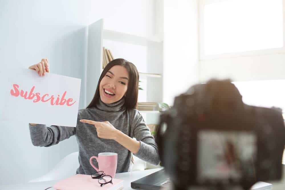 Women With Subscribe Written On Paper